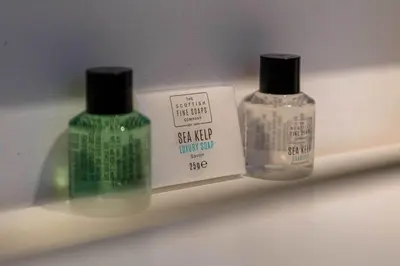 two bottles of soap sitting on a shelf at The Bradshaw in Prestwick