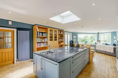 a kitchen with a large island with two sinks at Balcary Tower in Castle Douglas