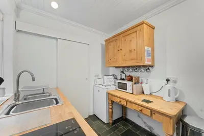 a kitchen with a sink and a counter with a microwave at The Escape in Portinscale