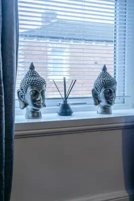 two head statues sitting on a window sill at CS House in Carlisle