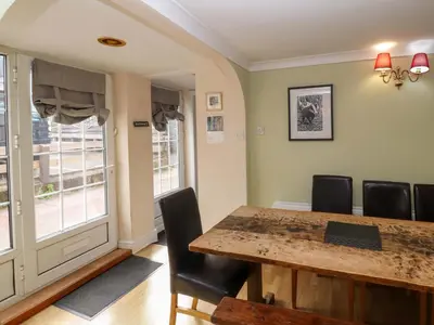 a dining room with a table and chairs at Brews Cottage in Keswick