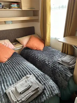 a bedroom with two beds and a window at Ralfgus 16 Forest Views caravan Park,Moota in Plumbland