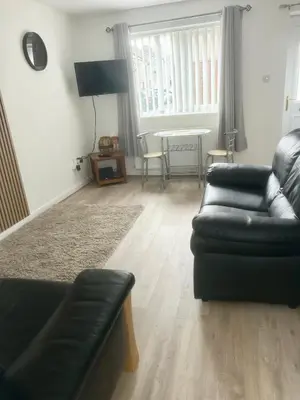 a living room with a couch and a table at CosyHouse1 Private Parking Base for Lake District and Sellafield in Cleator