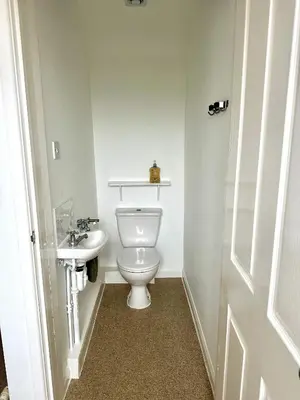 a bathroom with a toilet and a sink at CosyHouse1 Private Parking Base for Lake District and Sellafield in Cleator