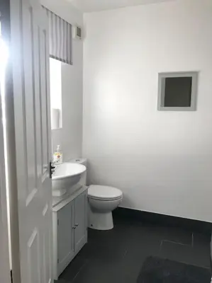 a white bathroom with a toilet and a sink at Spacious Property For Hols Base & Contractors Long or Short Stays C2C Western Lakes in Cleator Moor