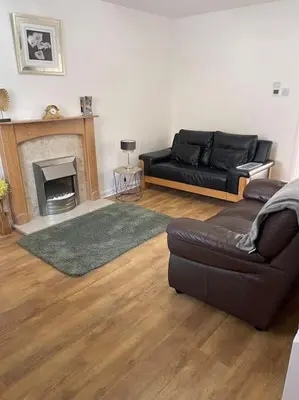 a living room with a couch and a fireplace at CosyHouse2 Private Parking Base for Lake District and Sellafield in Cleator Moor