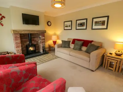 a living room with a couch and a fireplace at The Stables at Daldorch in Mauchline
