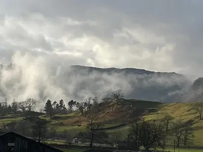 a view of a mountain with clouds in the sky at The Shepherd's Nook in Thirlmere