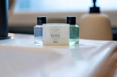 three bottles of soap sitting on top of a table at The Fairlie Suite No2 in Prestwick