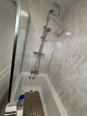 a bathroom with a shower and a bath tub at No 10, Ayr, 130m2, New Decor December 2024, All new entire 3 bedroom garden house in Ayr