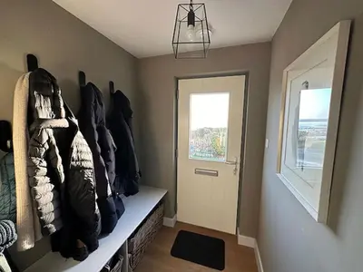 a room with a hallway with a door and a window at Whitegates in Rockcliffe