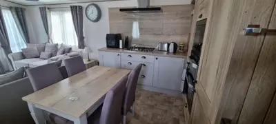 a kitchen and dining room with a table and a couch at Ramblers Retreat in Cockermouth