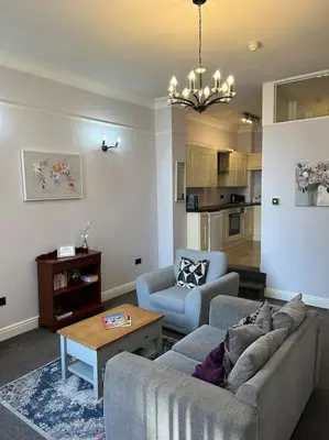 a living room with a couch and two chairs and a table at 10 Thurnams House in Carlisle