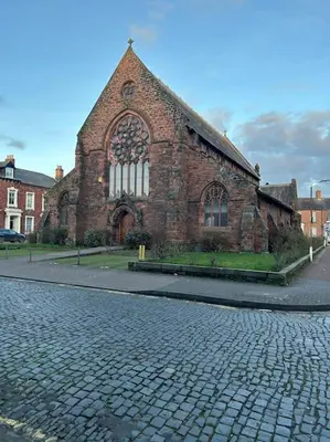 an old brick church with a brick road in front of it at 10 Thurnams House in Carlisle