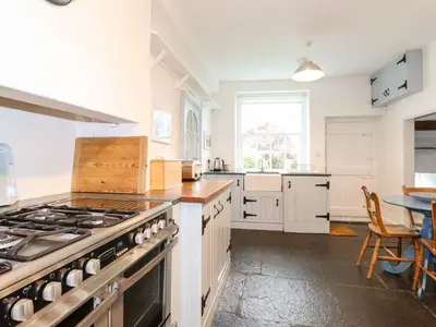 a large kitchen with a stove and a table at Middletown in Keswick