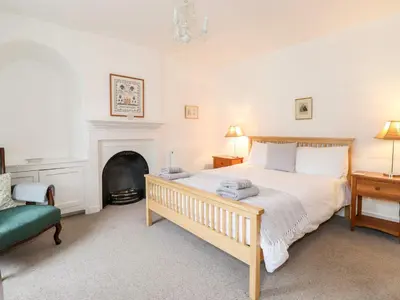 a bedroom with a large bed and a fireplace at Middletown in Keswick
