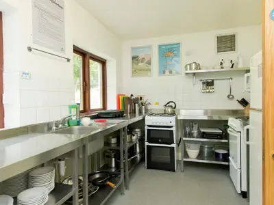 a kitchen with stainless steel counter tops and appliances at YHA Ennerdale in Buttermere