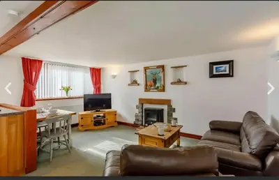 a living room with a couch and a table at Troutbeck Inn Cottages in Troutbeck
