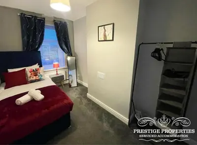 a bedroom with a bed with a red bedspread at Jackson St by Prestige Properties SA in Siddick
