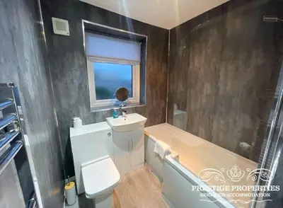 a bathroom with a toilet and a sink and a tub at Jackson St by Prestige Properties SA in Siddick