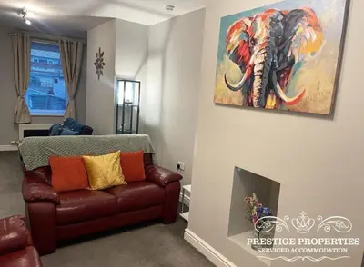 a living room with a couch and a painting of an elephant at Jackson St by Prestige Properties SA in Siddick