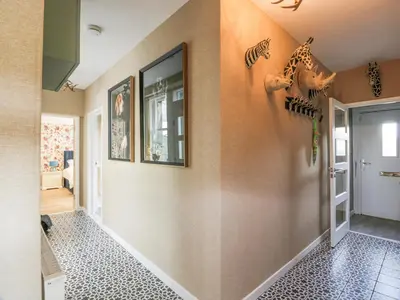 a hallway with a wall with a giraffe decorations at Waterside Lodge in Lockerbie