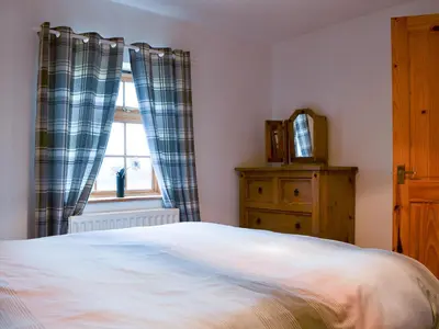 a bedroom with a bed and a window and a dresser at Meadow Lodge-E4105 in Aspatria