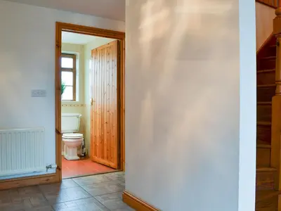 a hallway with a toilet and a door to a bathroom at Meadow Lodge-E4105 in Aspatria