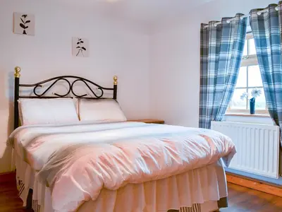 a bedroom with a bed and a window at Meadow Lodge-E4105 in Aspatria
