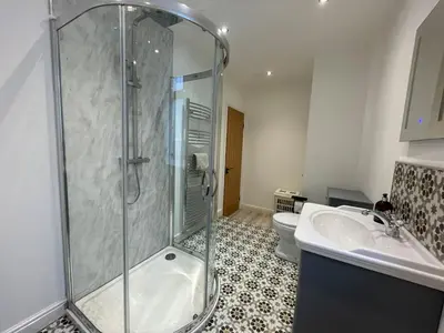 a bathroom with a shower and a toilet and a sink at Stunning Cosy Cottage in Historic Moffat - Pass the Keys in Moffat