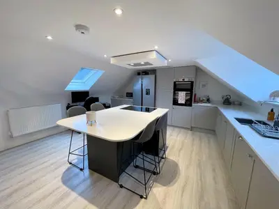 a kitchen with white counters and a white counter top at Stunning Cosy Cottage in Historic Moffat - Pass the Keys in Moffat