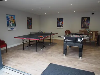 two ping pong tables in a room with two tables at Family and dog friendly stunning barn conversion in Tarbolton