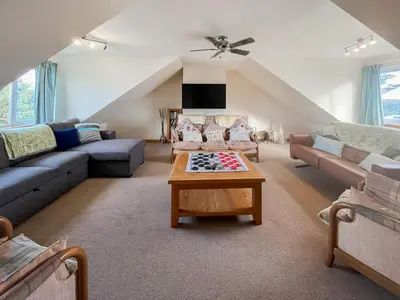 a living room with couches and a table at Quare Place in Mainsriddle