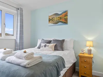 a bedroom with a bed with towels on it at Finest Retreats - Willow Dene in Cockermouth