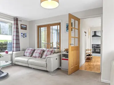 a living room with a couch and a table at Finest Retreats - Willow Dene in Cockermouth
