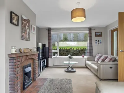 a living room with a couch and a fireplace at Finest Retreats - Willow Dene in Cockermouth