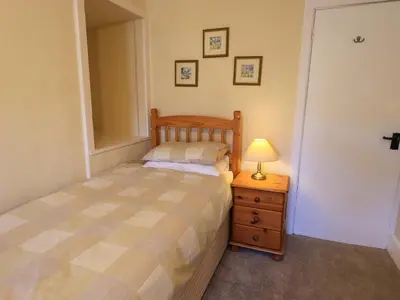 a bedroom with a bed and a lamp on a night stand at Lakeland View Lodge in Keswick