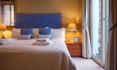 a bedroom with a large bed with towels on it at Underscar - Stonethwaite in Keswick