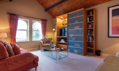 a living room with a couch and a glass table at Underscar - Stonethwaite in Keswick