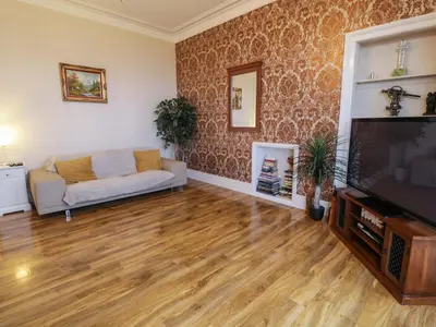 a living room with a couch and a flat screen tv at Ailsa View in Girvan
