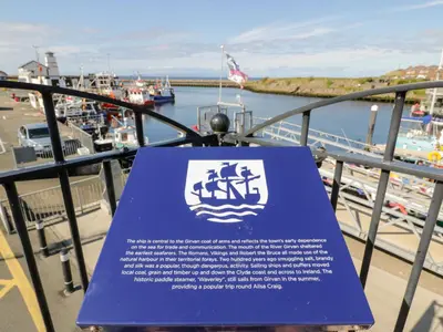 a blue sign on a balcony with a marina at Ailsa View in Girvan