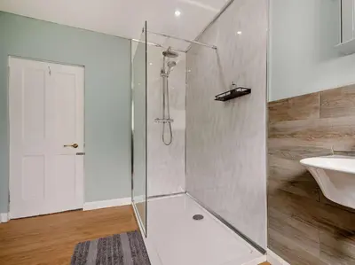 a bathroom with a shower and a sink at 2 Bed seafront cottage in Portpatrick in Portpatrick