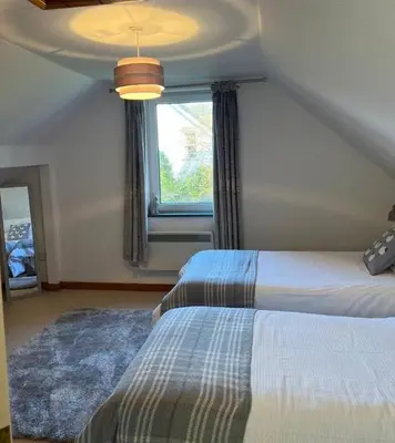a bedroom with two beds and a window at Maiden Moor in Borrowdale Valley