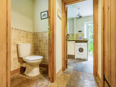 a bathroom with a toilet and a washing machine at 3 Bed in Keswick oc-sz080 in Braithwaite