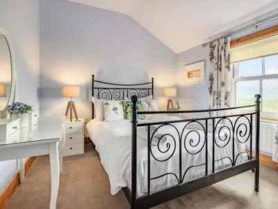a bedroom with a bed and a desk and a window at 3 Bed in Keswick oc-sz080 in Braithwaite