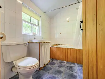 a bathroom with a toilet and a sink and a tub at 3 Bed in Keswick oc-sz080 in Braithwaite