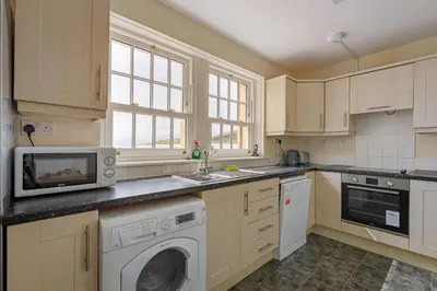 a kitchen with a microwave and a washer and dryer at 3 Bed in Drummore oc-p30213 in Drummore