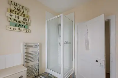 a white bathroom with a shower and a toilet at 3 Bed in Drummore oc-p30213 in Drummore
