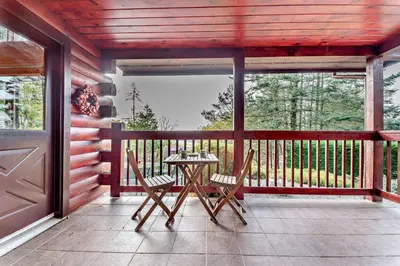 a patio with a table and chairs on a porch at 3 Bed in Kippford oc-g30100 in Kippford