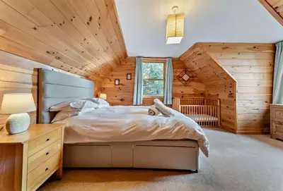 a bedroom with a bed and a wooden ceiling at 3 Bed in Kippford oc-g30100 in Kippford